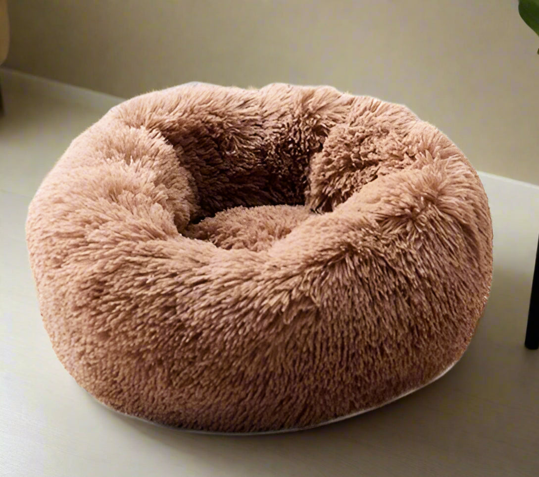 Fluffy brown pet bed on a white background
